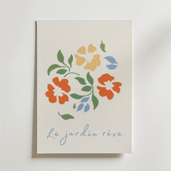 Bozetto Le Jardin Reve Flower Poster på premiumpapper visar stiliserade orange, gula och blå blommor med gröna blad och "Le jardin rêve" i ljusblå kursiv stil. FSC-certifierad för hållbarhet.