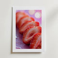 En närbild av färska, skivade jordgubbar med vattendroppar på en mjuk rosa bakgrund finns på Bozetto Sweet Slice Poster. Tryckt med en vit kant på exklusivt premiumpapper skapar den en harmonisk atmosfär.