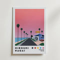Bozetto Hiroshi Nagai Sunset Coast Poster föreställer en rosa solnedgång över en palmkantad kustväg som leder till en akvariebyggnad, med "Hiroshi Nagai Tokyo 1973" och färgade prickar längst ner.