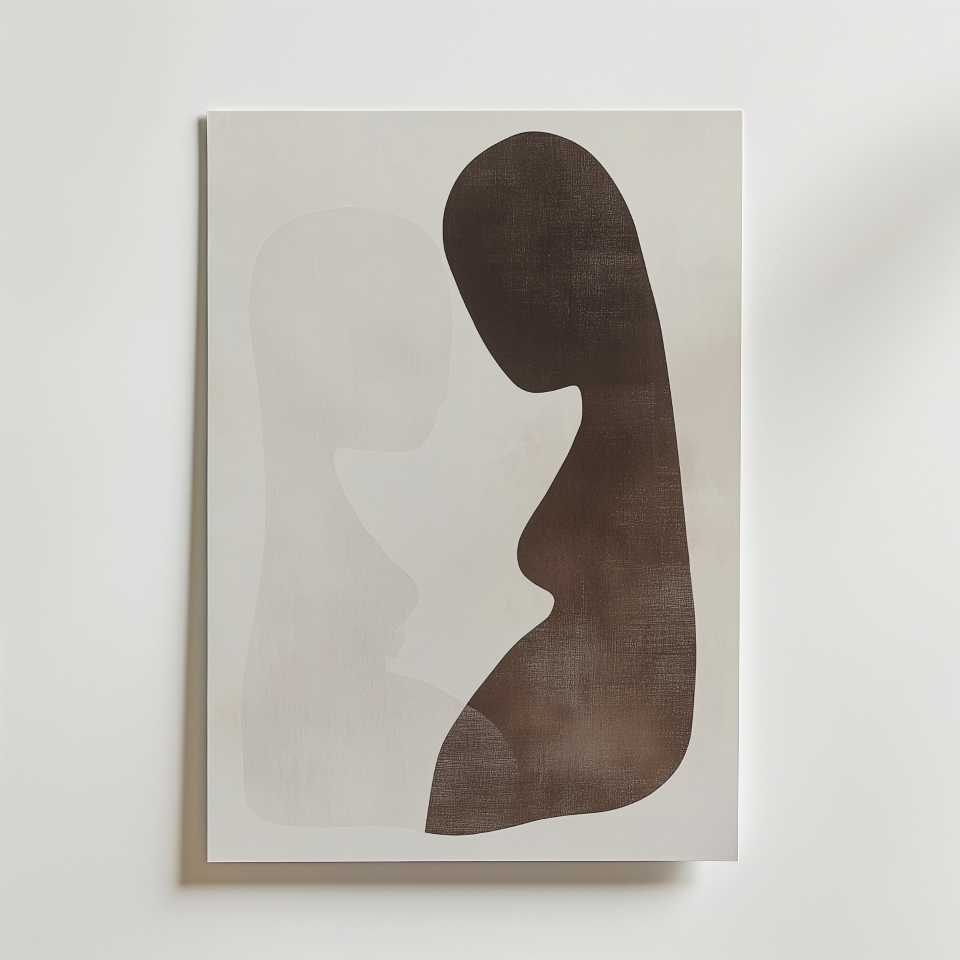 Postern Abstract Lovers från Bozetto har två överlappande silhuetter i ljus beige och mörkbrun på vit botten, tryckt på premiumpapper med en lyxig matt finish för en sofistikerad, modern look.